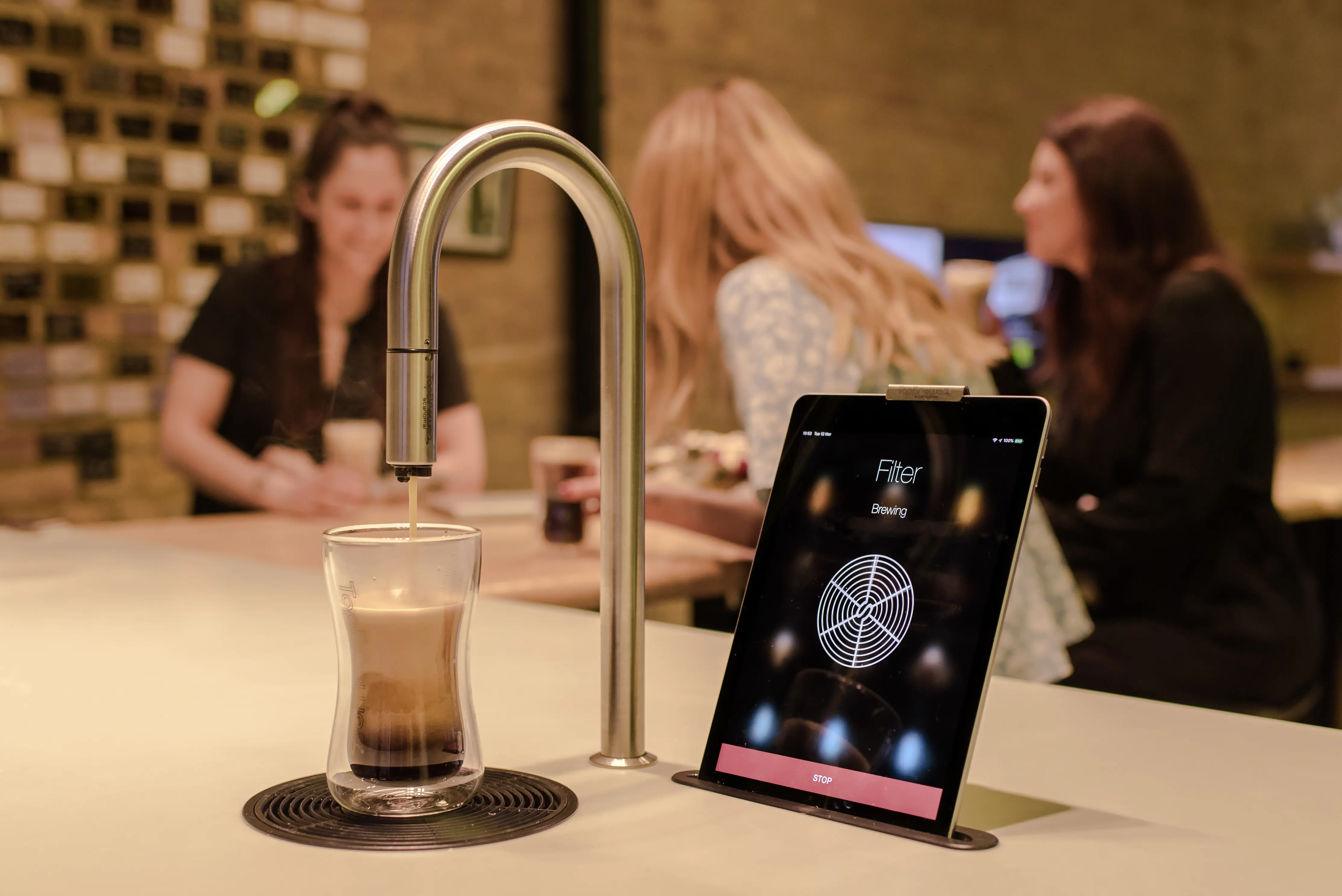 Capco TopBrewer installation, showing TopBrewer at front and colleagues chatting in the background