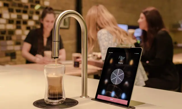 Capco TopBrewer installation, showing TopBrewer at front and colleagues chatting in the background