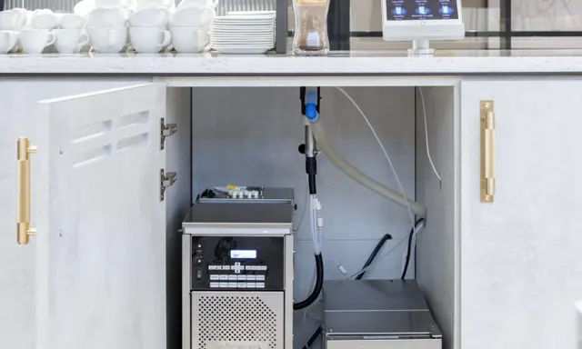 Image showing the under-counter set up of a TopBrewer commercial coffee machine