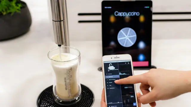 CoffeeCloud close up, showing menu on the app with TopBrewer in the background