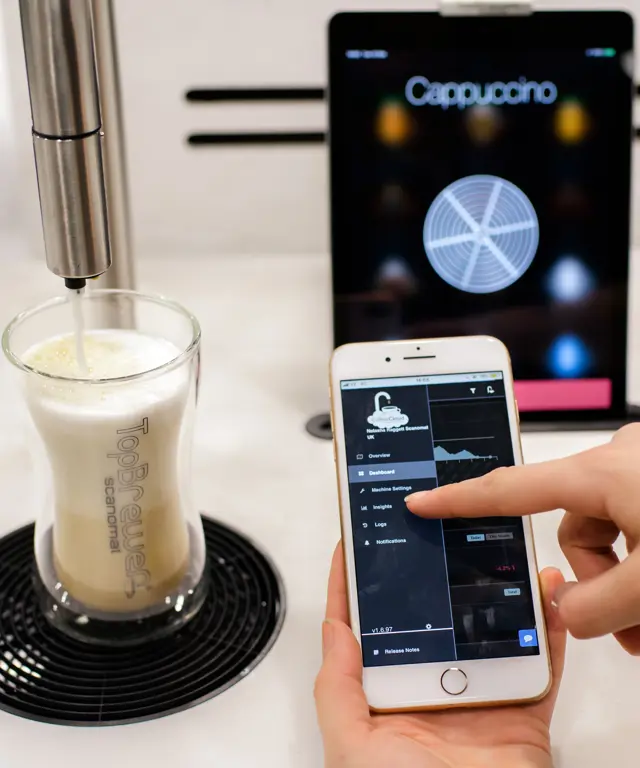 CoffeeCloud close up, showing menu on the app with TopBrewer in the background