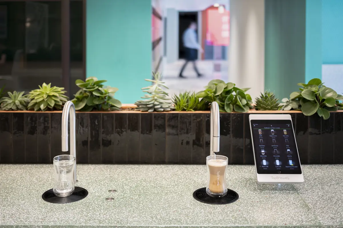 Image showing a TopBrewer commercial coffee machine on the right and a TopWater water dispenser on the left, both are built into the counter