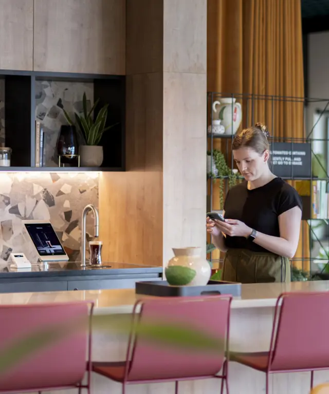 Wide shot in Uncle Southall showing a TopBrewer coffee machine and people in the background
